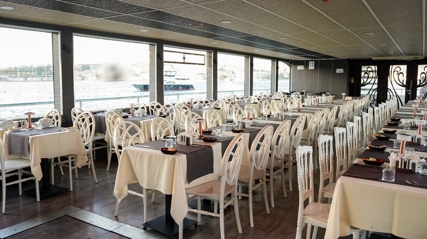 The dining salon with tables laid along the windows