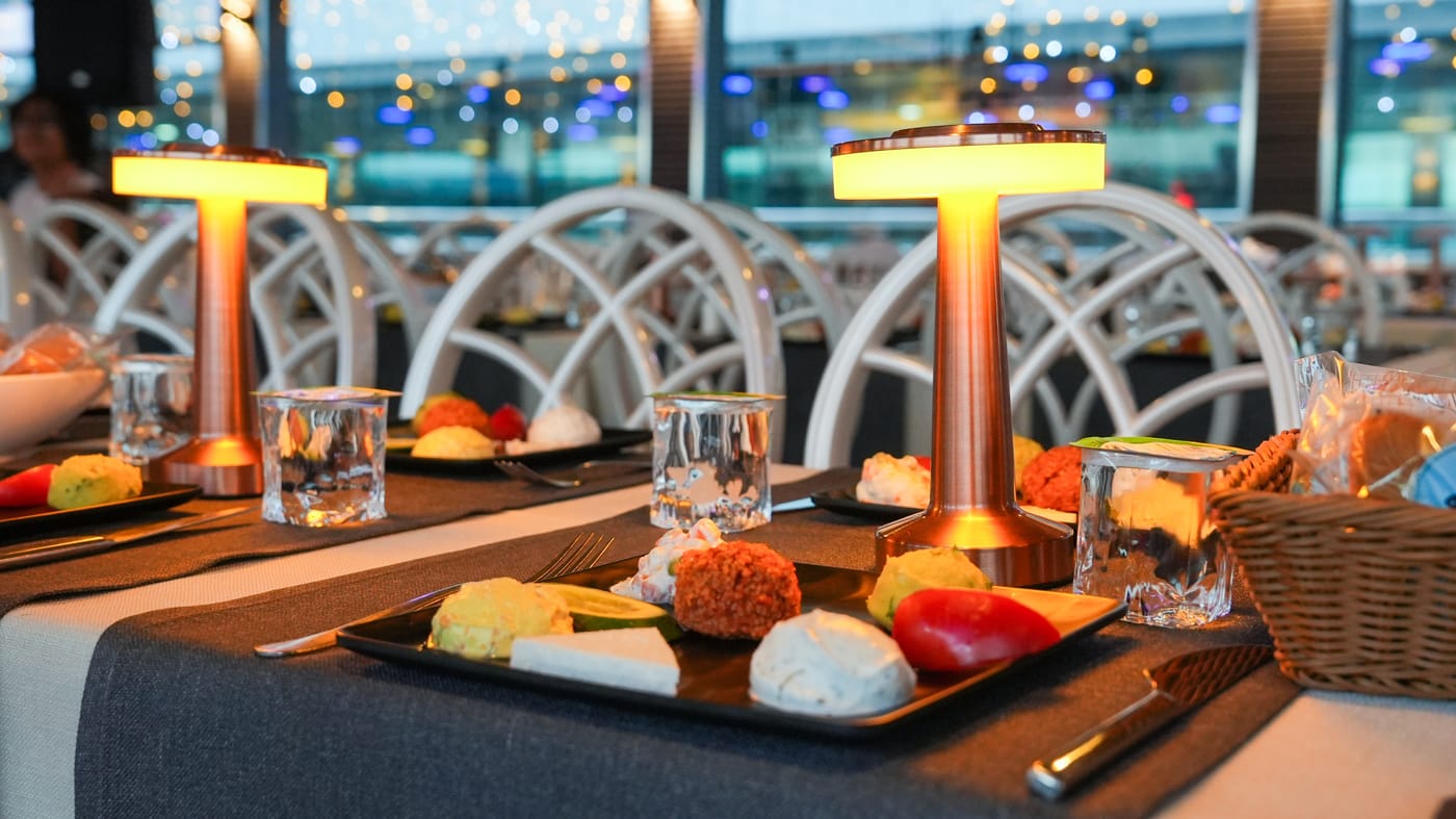 Turkish meze spread served on a candlelit Bosphorus dinner cruise table