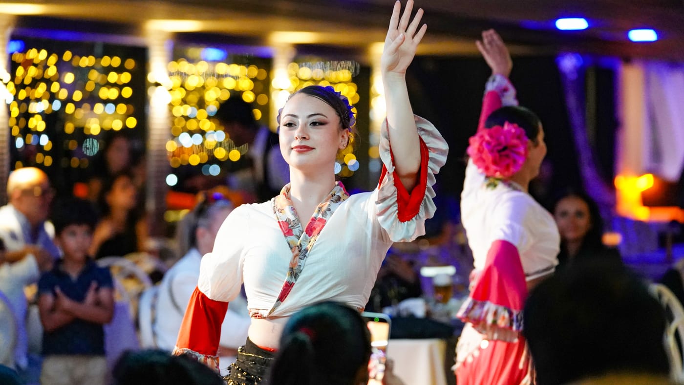 Two dancers in white and red costumes