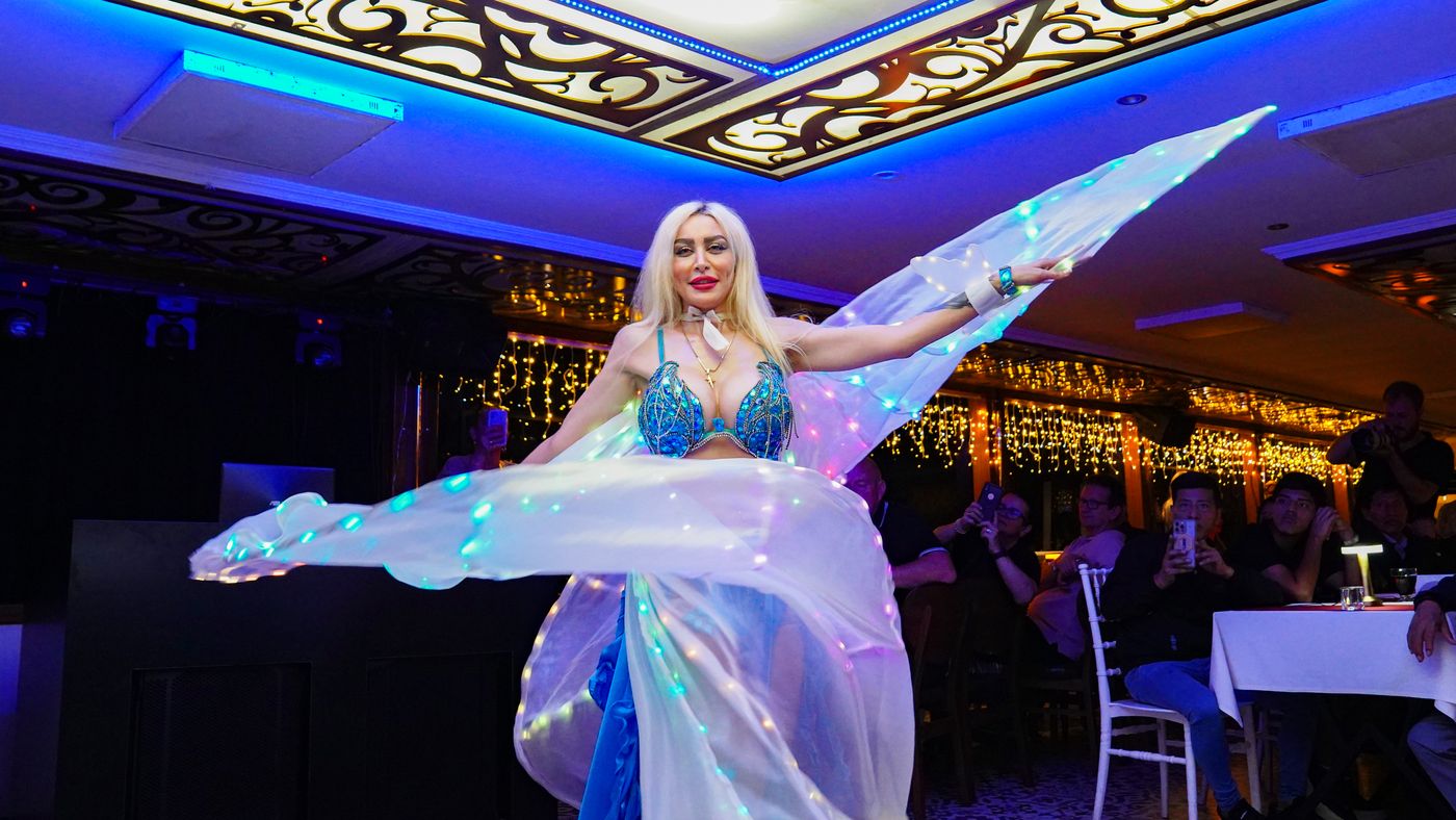 Belly dancer with illuminated veil wings
