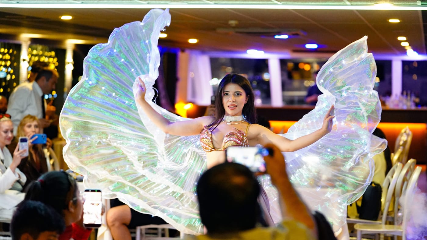Glowing wings sweep across the stage floor