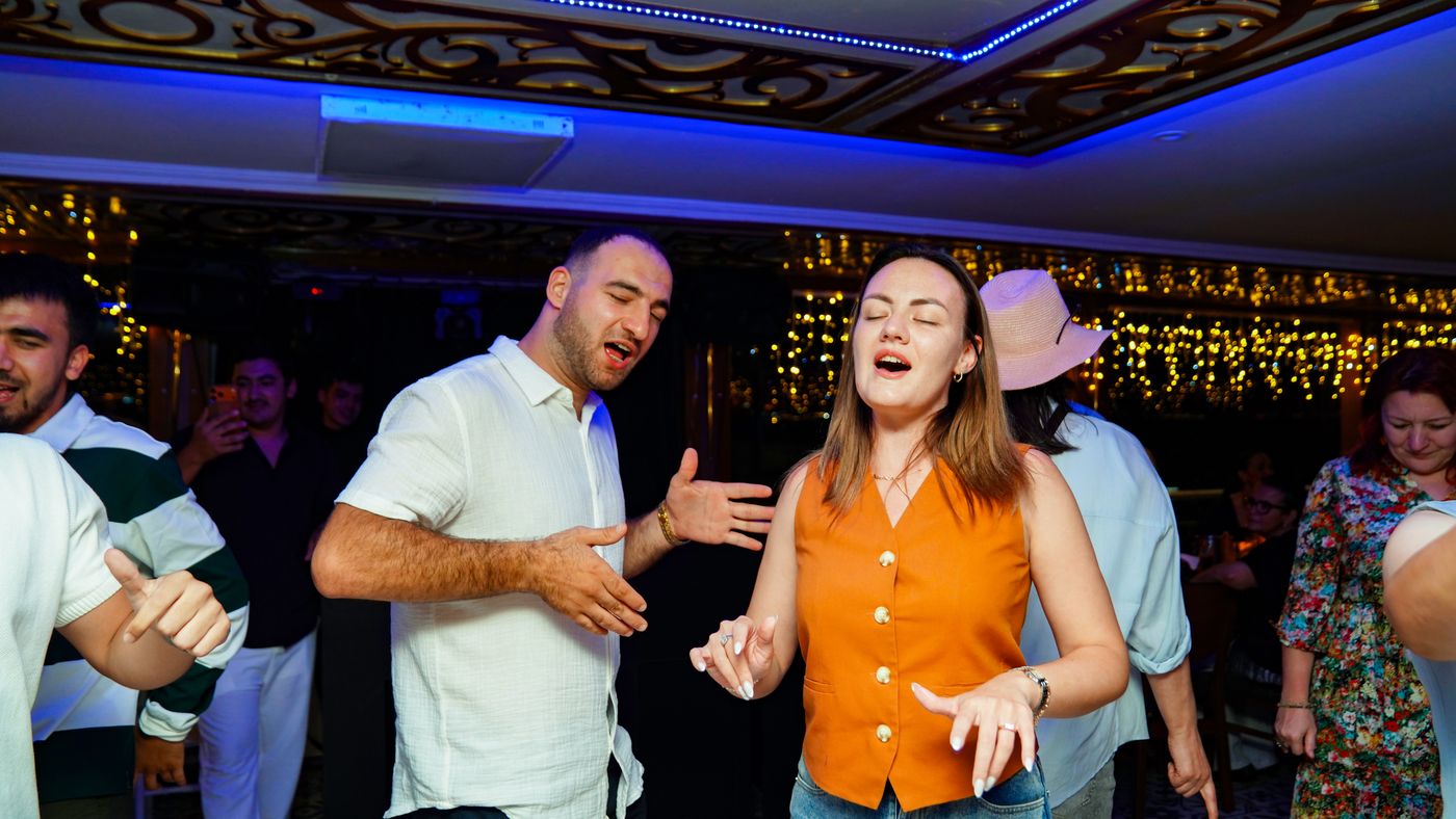 Eyes closed, a couple sings the chorus