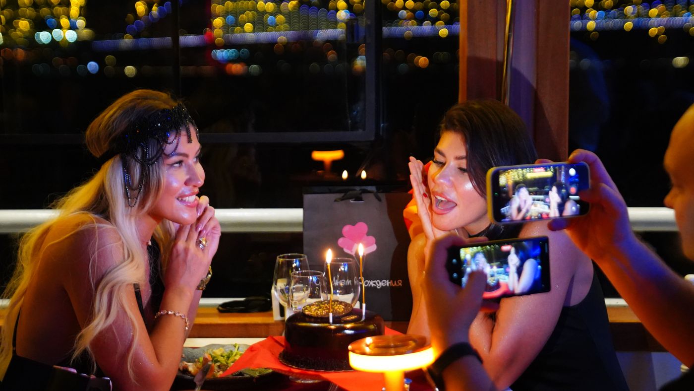 Birthday cake with candles at a window table
