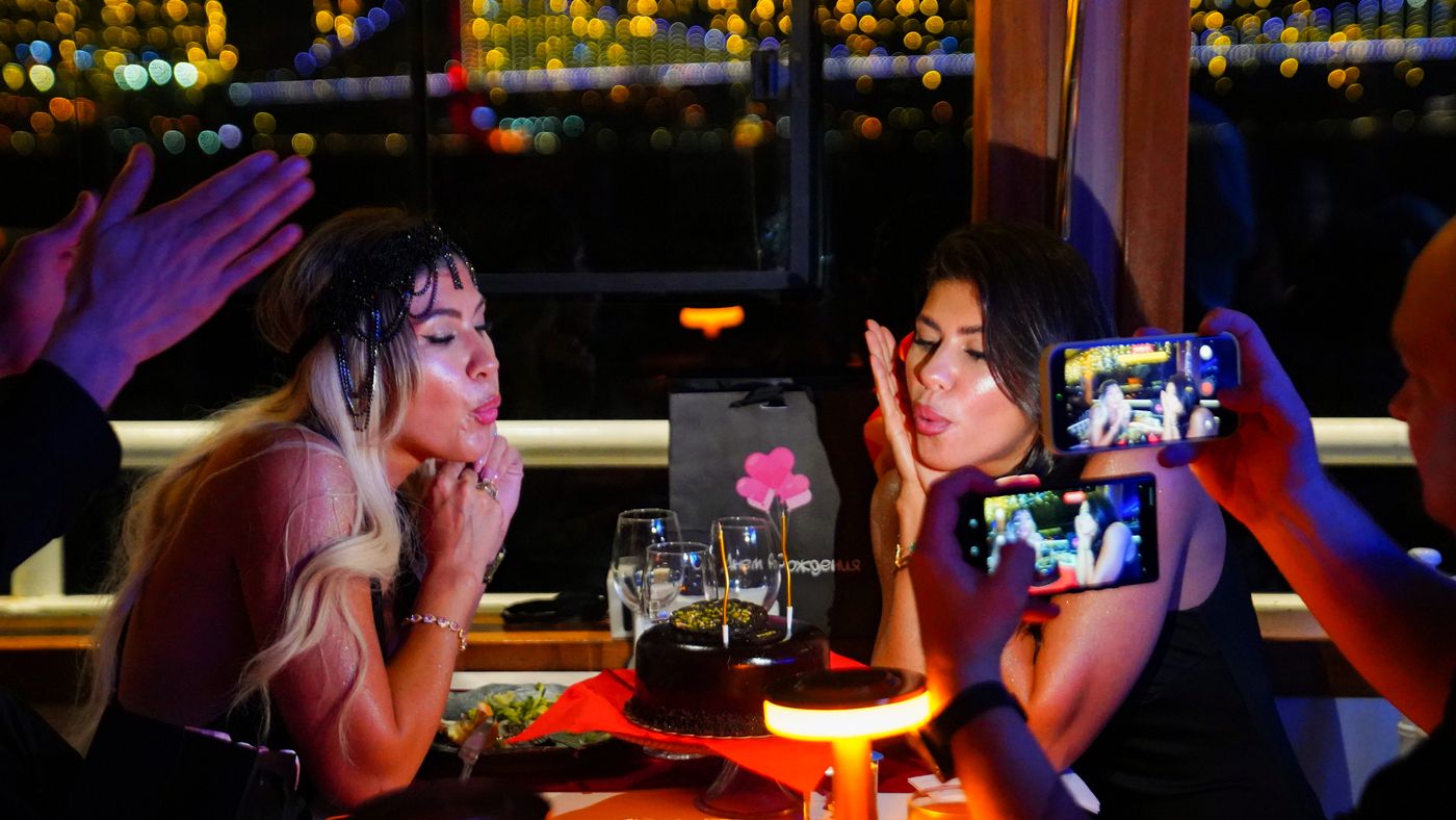 Blowing kisses over the birthday cake