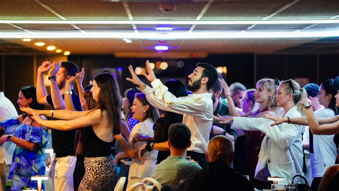 Guests sway to the music under the lights