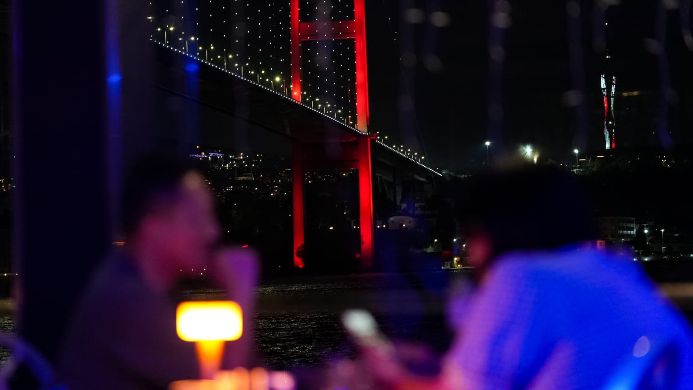 The lit Bosphorus Bridge through the salon window