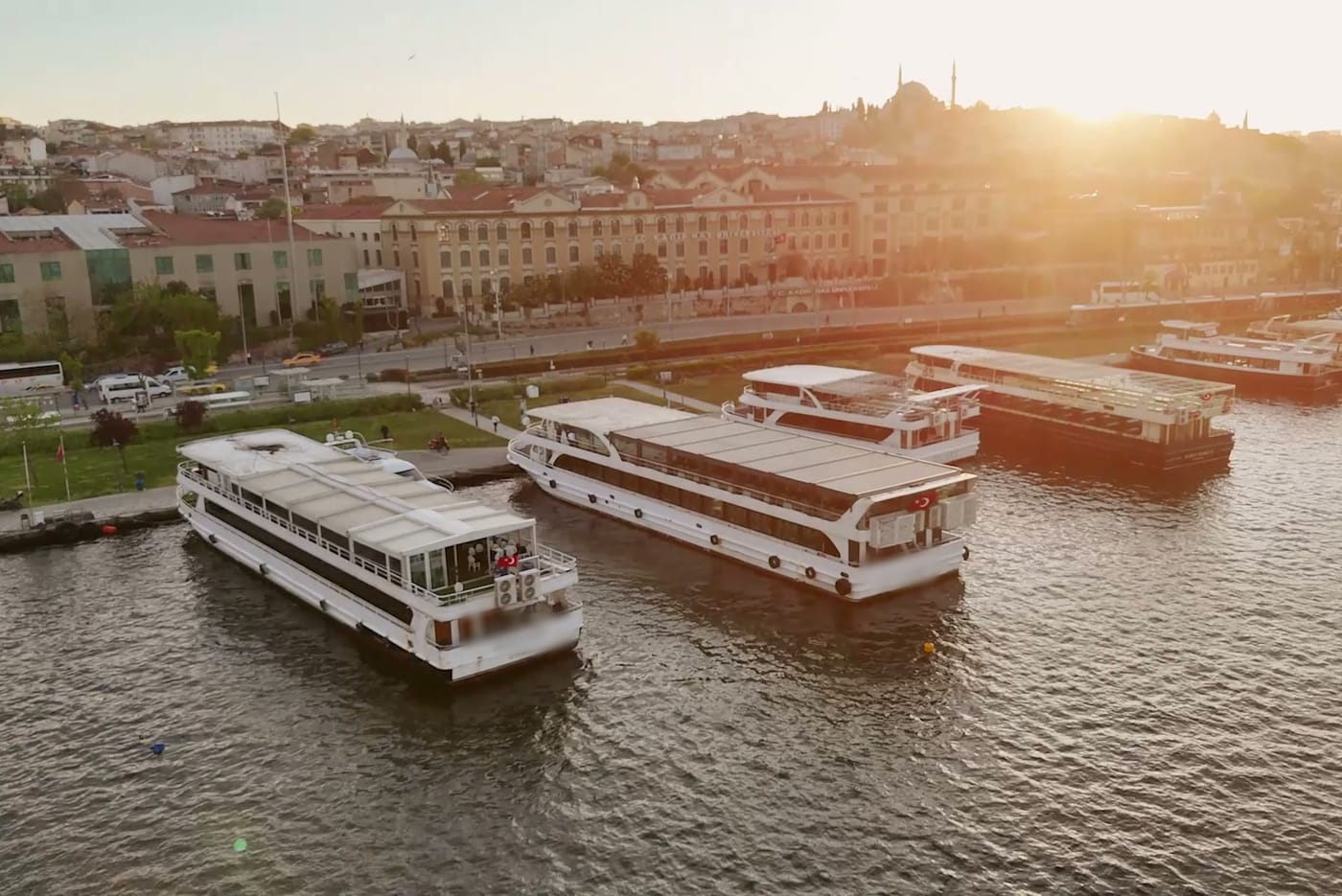 Dinner-cruise boats moored at Cibali Pier on the Golden Horn at sunset, the old city behind